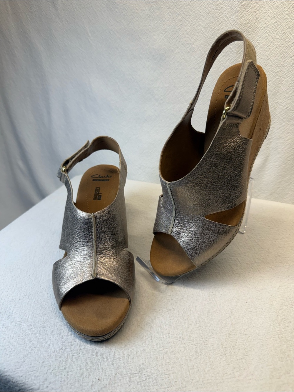 Streetwear Clarks Helio Float wedge sandals in pewter or gold metallic leather.